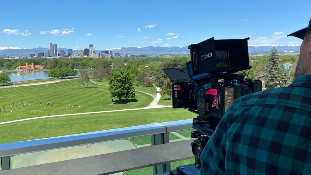 Cinema camera filming the Denver skyline from a park