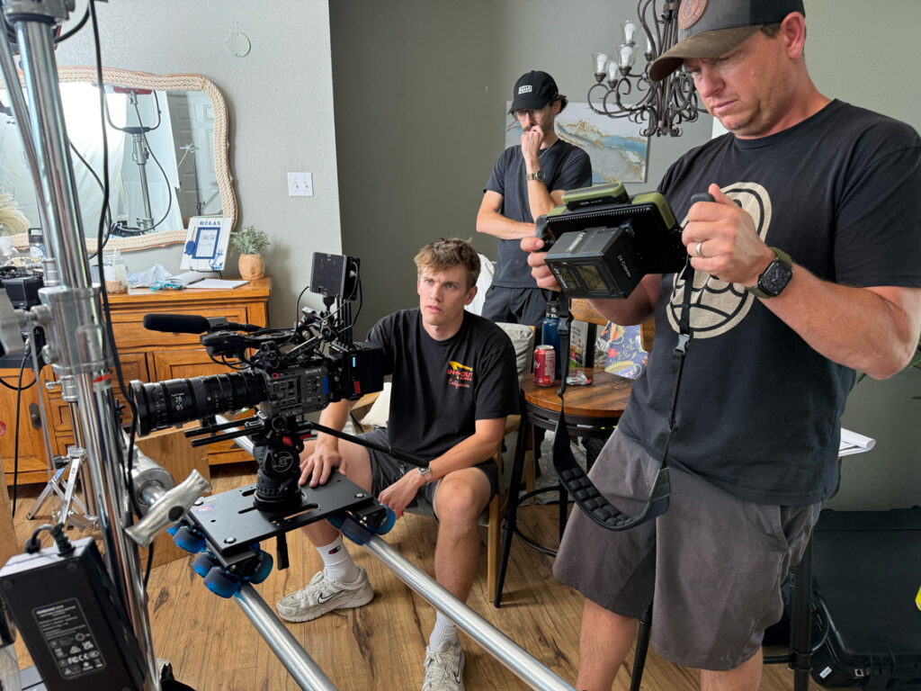 Sony FX6 with a cinema zoom on a Dana Dolly as the director checks the shot on a handheld monitor during a commercial shoot in Decatur, Texas